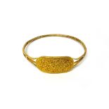 A gold circular bangle, the front curved panel decorated with blossom and floral sprays, diameter 9.