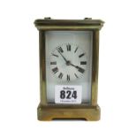 A French brass cased carriage clock, early 20th century, with white enamel dial,