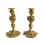 After Juste Aurèle Meissonier, a pair of French Rococo style ormolu candlesticks, late 19th century,