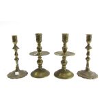 A pair of 18th century Dutch brass baluster candlesticks with circular domed base, 21cm high,