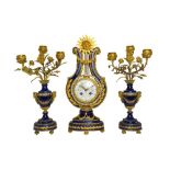 A Louis XVI style blue porcelain and ormolu mounted clock garniture, c.