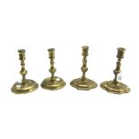 A pair of early Queen Anne brass baluster candlesticks with lozenge stepped bases,
