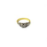 A gold and diamond ring, mounted with the principal circular cut diamond at the centre,