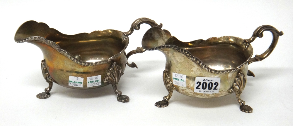 A pair of silver sauceboats, each decorated with a shaped gadrooned rim,