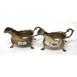 A pair of silver sauceboats, each decorated with a shaped gadrooned rim,