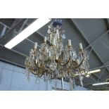 A Louis XV style eighteen branch brass and cut glass chandelier,