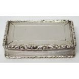 A Victorian silver rectangular snuff box, decorated to the borders of the lid and to the base,