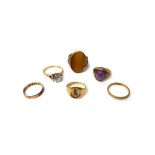 A 9ct gold ring, mounted with an oval tiger's eye, a 9ct gold ring,