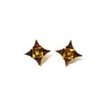 A pair of 18ct gold, citrine and garnet set earclips,