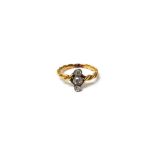 A gold and diamond set three stone ring, mounted with cushion shaped diamonds,