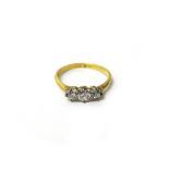 A gold and diamond set three stone ring,