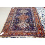 An Afshar Khamseh rug, Persian, the indigo field with a madder and two ivory diamonds,