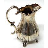 A Victorian silver milk jug, of baluster form, with fluted and engraved decoration,