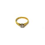 An 18ct gold and platinum, diamond set single stone ring, claw set with a circular cut diamond,