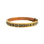 A Victorian gold, cat's eye and seed pearl set oval hinged bangle,