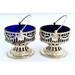 A pair of George III silver salts, each of oval form,