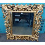 A rococo revival gilt framed mirror with extensive acanthus scroll frame, 86cm wide x 95cm high.