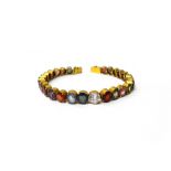 A gold and vary coloured gemstone and paste set bracelet, possible Ceylonese, on a snap clasp,