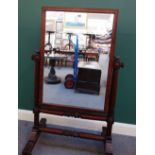 A William IV mahogany cheval mirror, with square plate, on lappet carved turned supports, 90cm wide.