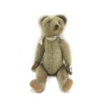 A Steiff musical teddy bear, 20th century, with golden fur, glass eyes and jointed limbs, 53cm high.