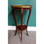 A Louis XVI style gilt bronze mounted mahogany gueridon of two graduated circular tiers on four