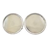 A pair of George III circular silver salvers, James Young, London 1791, with threaded rims,