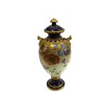 A Royal Crown Derby porcelain baluster vase and cover, painted with flowering branches,