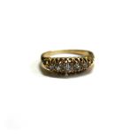 An early 20th century gold and diamond five stone ring, the graduated old cut stones approx. 0.