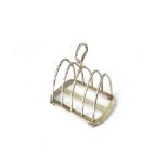 An Arts & Crafts silver five bar toast rack, Hukin & Heath, Birmingham 1921, the arched divisions,