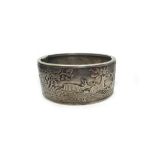 An early 20th century white metal broad hinged bangle,