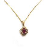 A modern 9ct gold, ruby and diamond pendant,