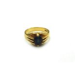 An early 20th century gold and oval mixed-cut sapphire gypsy ring, stamped 18ct, ring size K, 6.