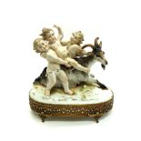 A German porcelain group, circa 1900, modelled as three putti on and around a goat,