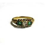 A late Victorian gold, emerald and diamond three stone ring,