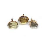 Three early 20th century and later gold and quartz three-sided spinning fobs,