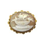A Victorian gold and oval shell cameo brooch depicting Pliny's doves, on a pale brown ground,