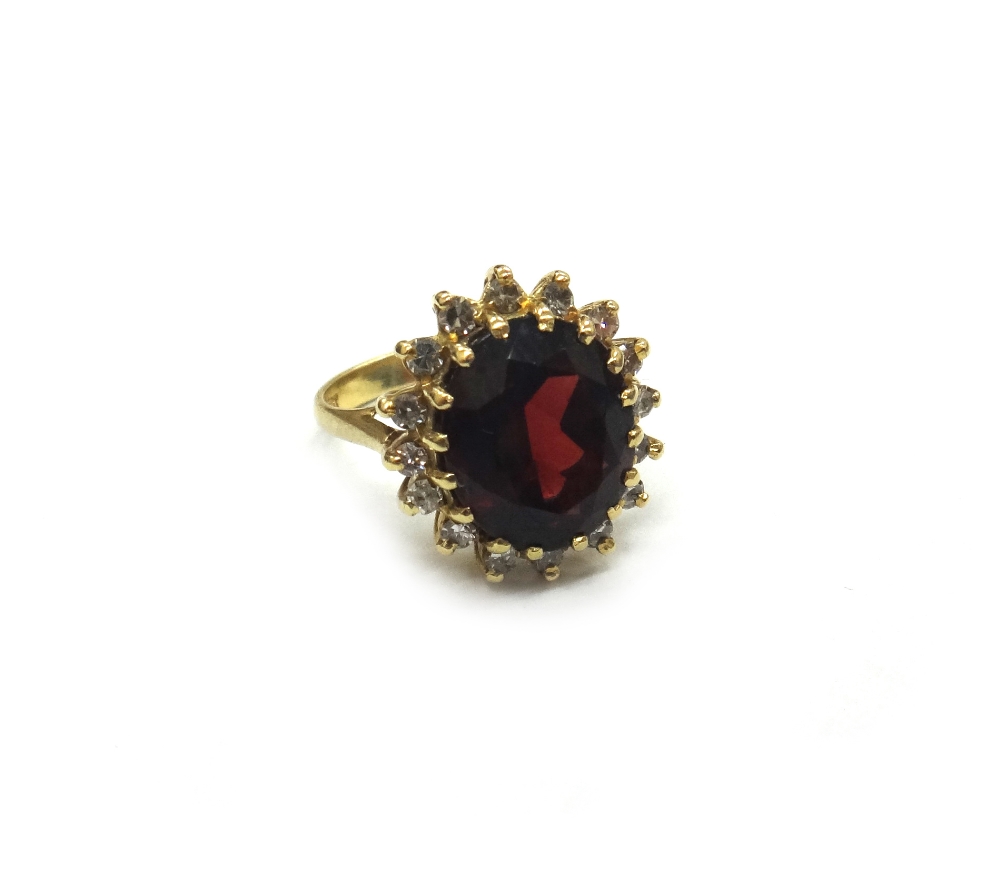 A garnet and diamond oval cluster ring,