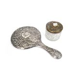 An Edwardian silver mounted hand mirror, Chester 1908, heavily foliate embossed,