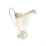 A George III style silver helmet cream jug, Wakeley & Wheeler, Dublin 1915, 13cm high, 4ozs.