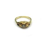 An early 20th century gold and diamond gypsy ring, centred with an old cut stone approximately 0.