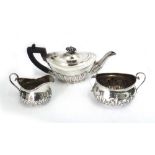 A bachelors late Victorian silver teapot, James Deakin & Sons, Sheffield 1899, oval,