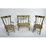 A doll's vintage painted wooden three-piece Windsor suite, the settee 22cm wide,