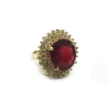 A ruby and diamond oval cluster ring,