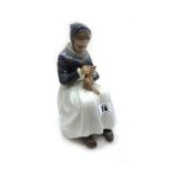 A Royal Copenhagen porcelain figure of a woman knitting, model no. 1317, 23cm high.