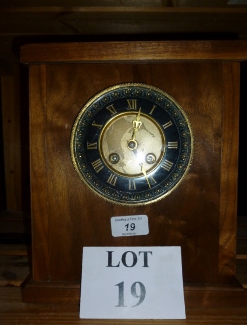 An American walnut clock with earlier mo