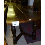 An 18c design solid oak refectory dining