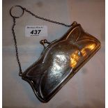 A silver engraved purse with leather int