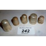 A collection of five silver thimbles var