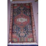 A Persian small rug (125 x 70 cm approx)