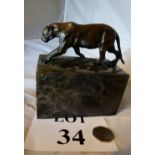 A patinated bronze model of a big cat,